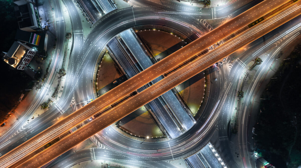 Aerial view elevated road traffic junctions, Modern construction design traffic ways traffic jams, Road interchange or highway intersection with busy urban traffic Junction network of transportation.